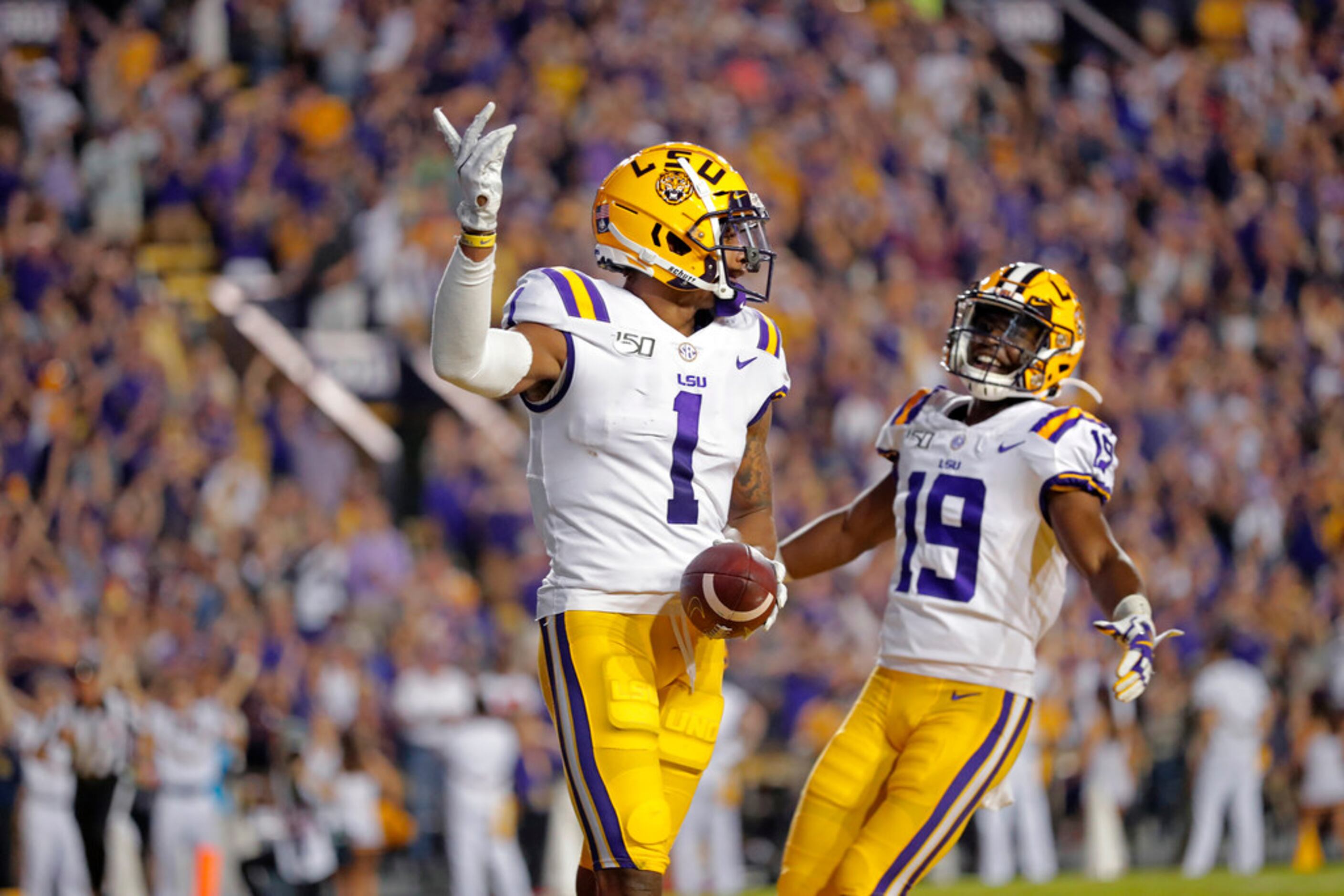 LSU wide receiver Ja'Marr Chase (1) celebrates his touchdown reception with wide receiver...