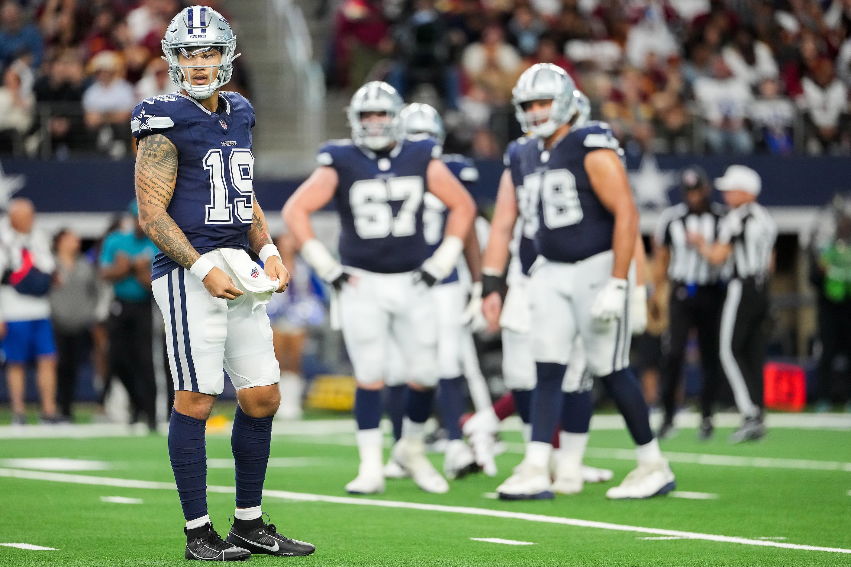 Dallas Cowboys quarterback Trey Lance (19) looks to the bench between plays during the...