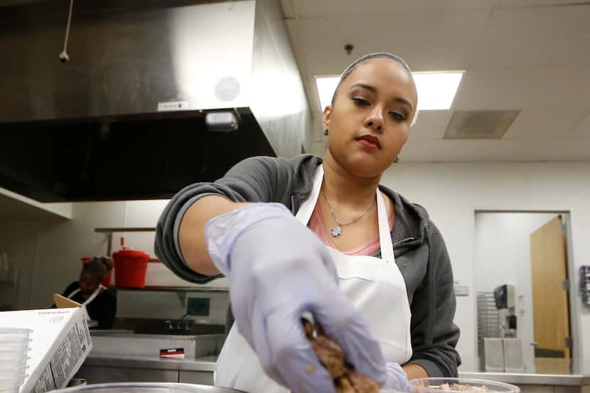 Stephanie Vasquez sorts pork out for Empanada Cookhouse at Pilotworks in Dallas. 