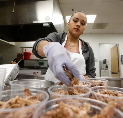 Stephanie Vasquez sorts pork out for Empanada Cookhouse at Pilotworks in Dallas. 