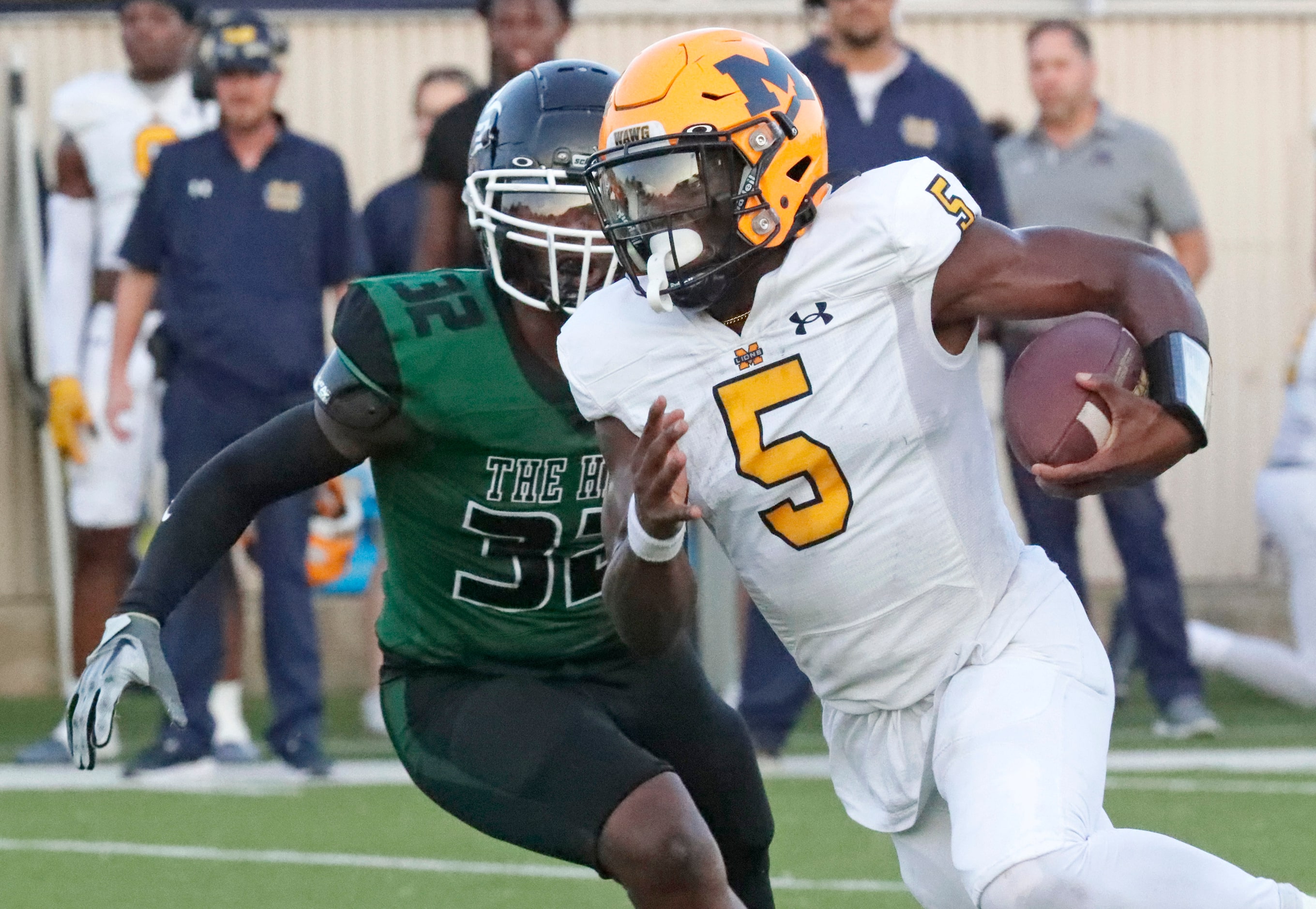 McKinney High School quarterback Godspower Nwawuihe (5) runs past Berkner High School...