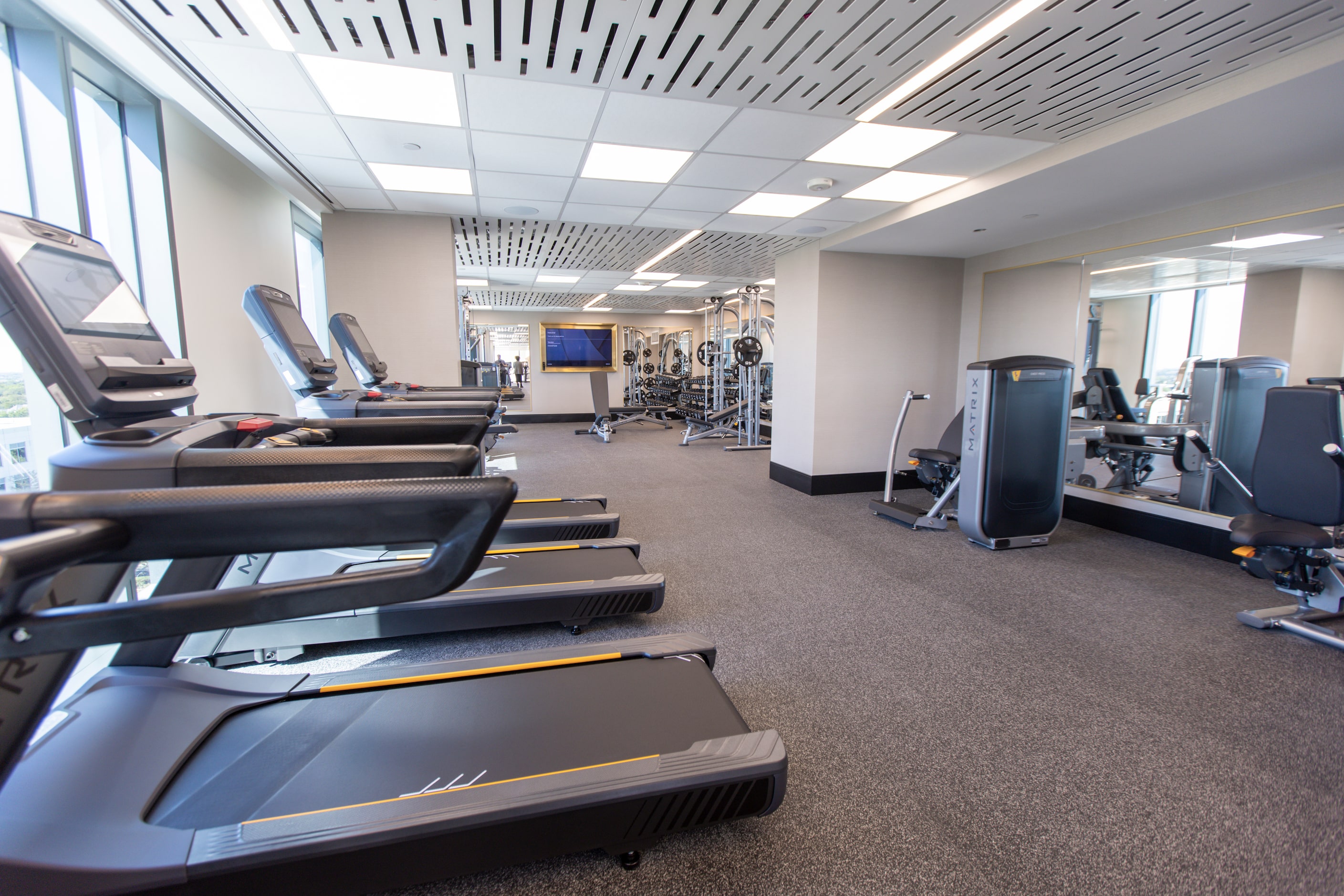 The fitness center, equipped with Peloton bikes and locker rooms, at the Hall Park Hotel is...