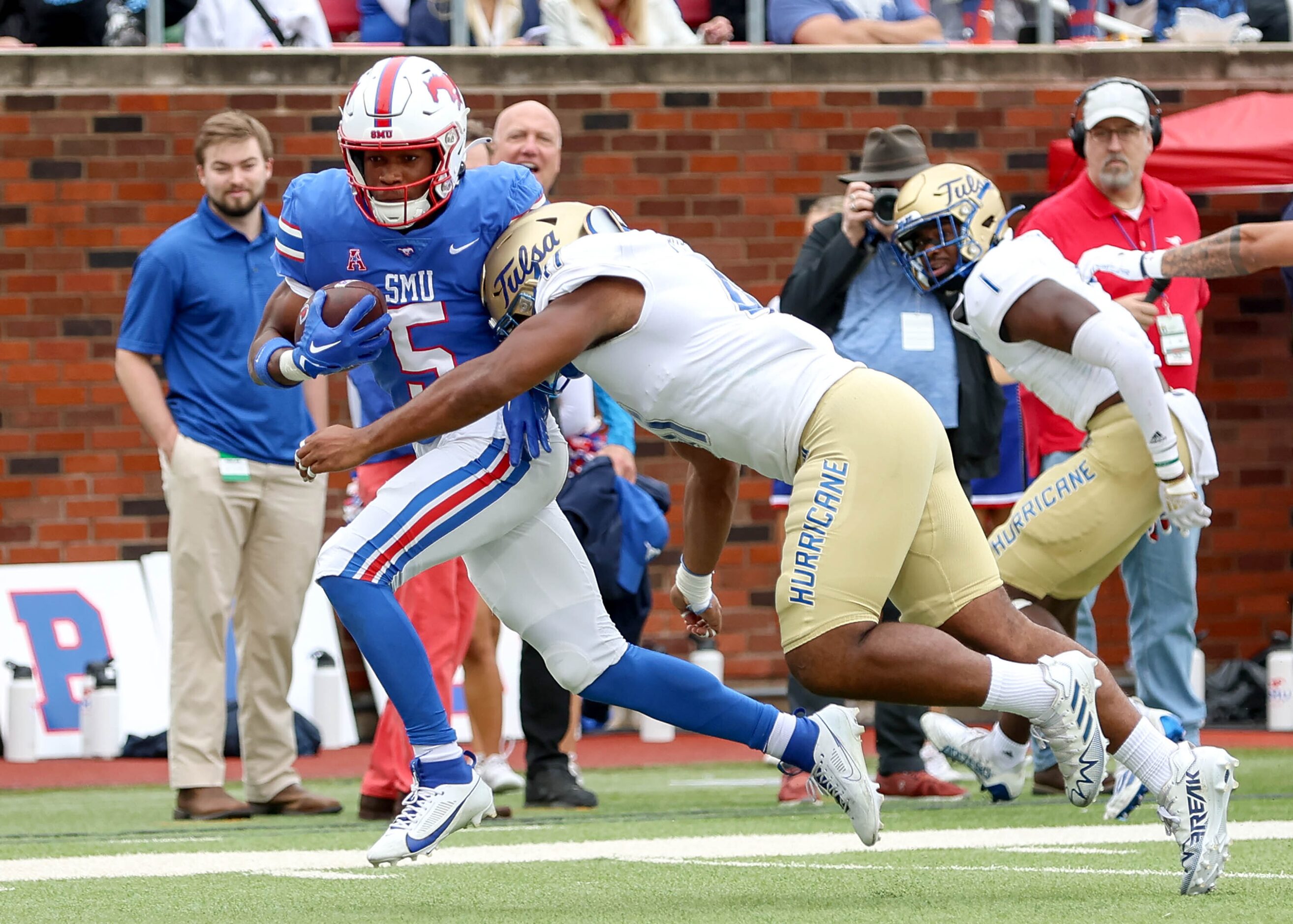 SMU wide receiver Moochie Dixon (5) fights his way to the end zone against Tulsa linebacker...