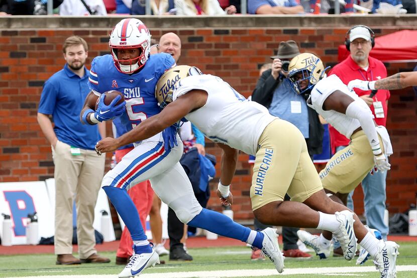 SMU wide receiver Moochie Dixon (5) fights his way to the end zone against Tulsa linebacker...