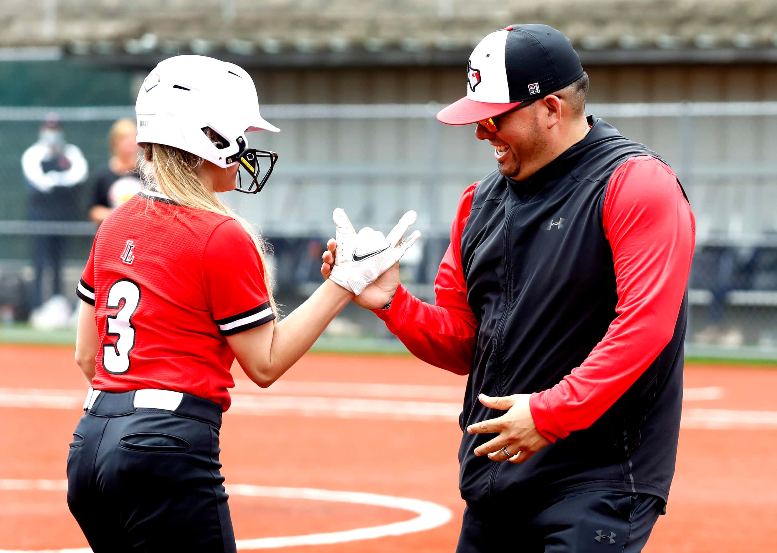 Lovejoy catcher Sydney Bardwell (3) is congratulated by head coach Shawn Lewis after an RBI...