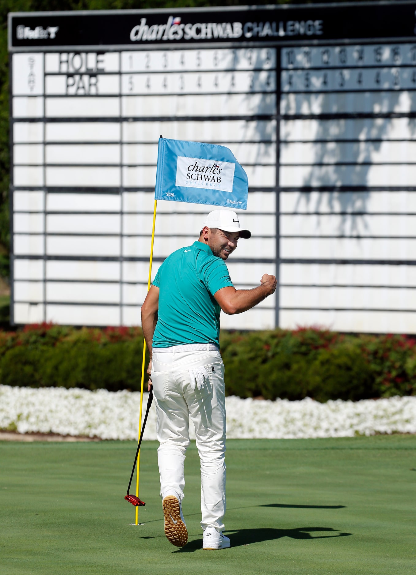 PGA golfer Jason Day turns to his caddie and pumps his fist after sinking a putt on No. 18...