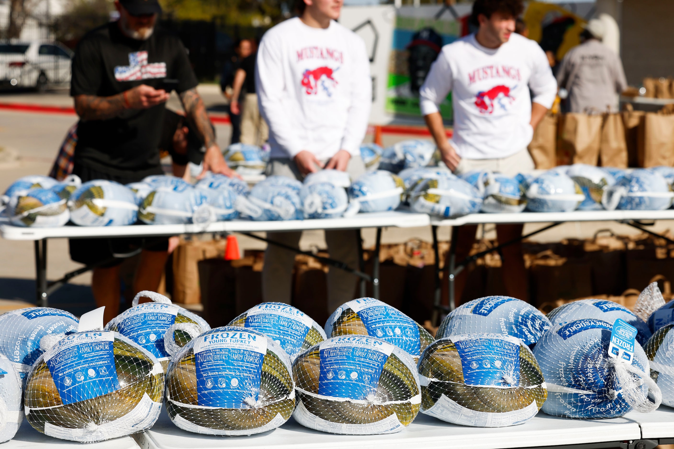 Packs of turkeys remain on the table during a free hand out by Southern Methodist University...