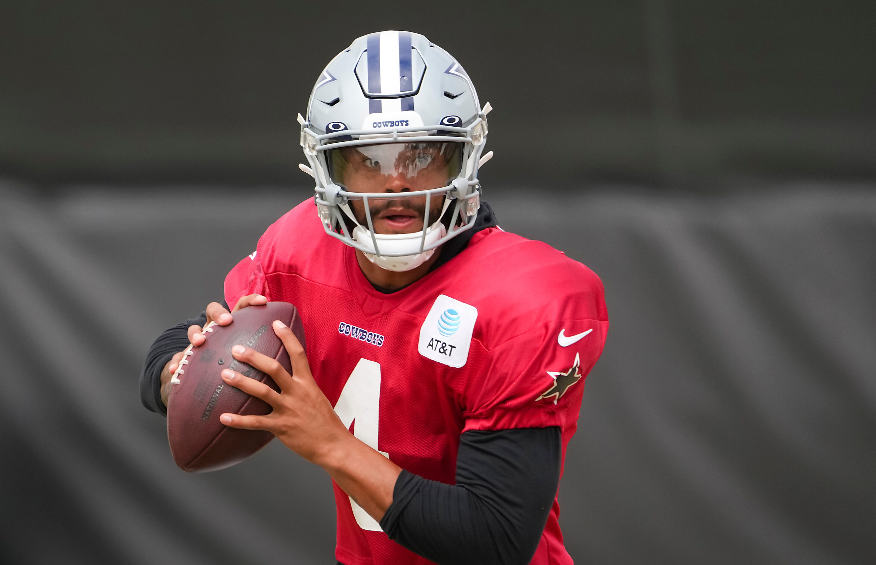 Dallas Cowboys quarterback Dak Prescott (4) runs a drill during a practice at training camp...