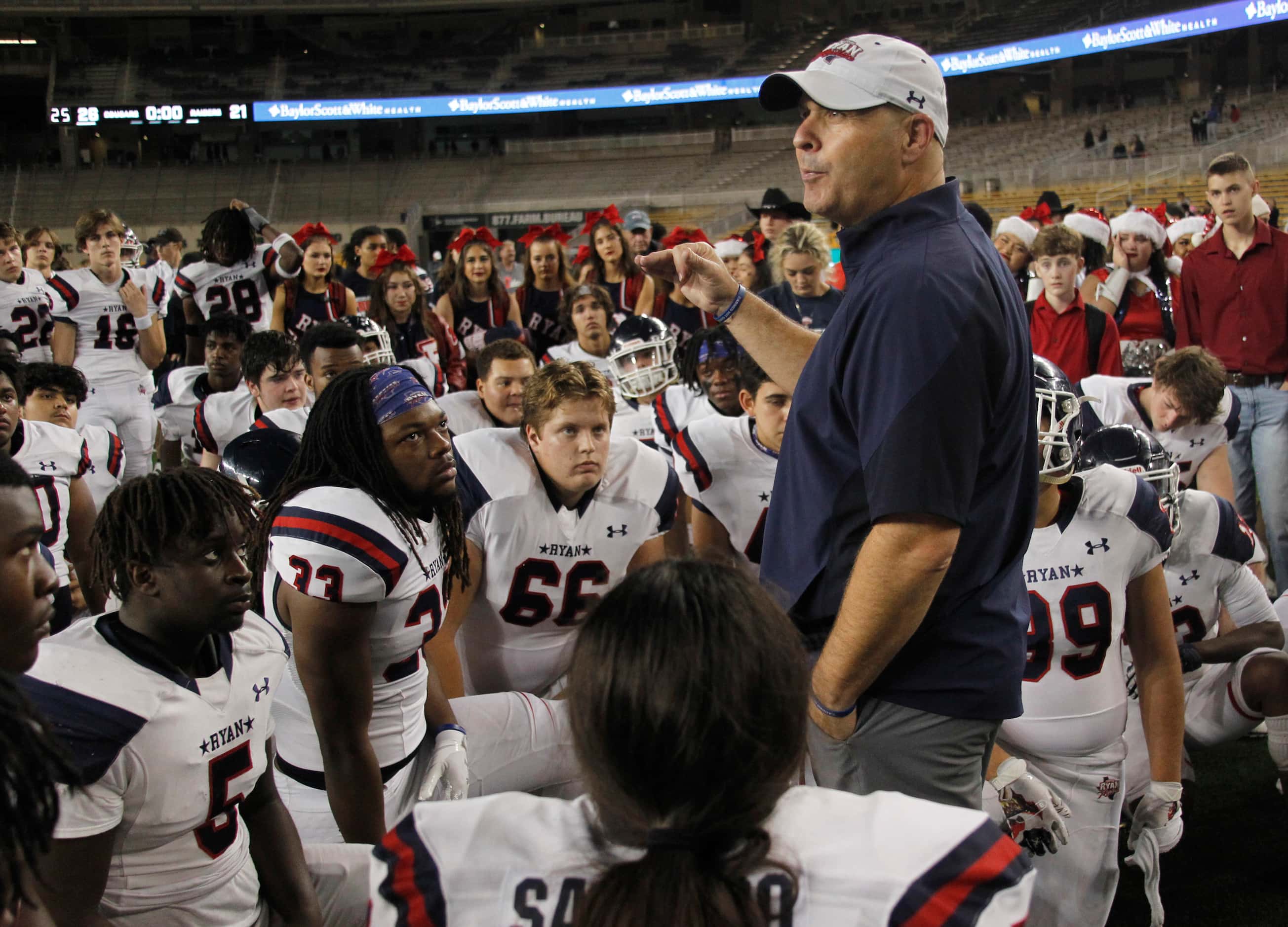 Denton Ryan head coach Dave Henigan shares an inspirational message to his players following...