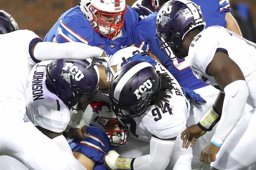 DALLAS, TX - SEPTEMBER 07:  Ben Hicks #8 of the Southern Methodist Mustangs is tackled by...