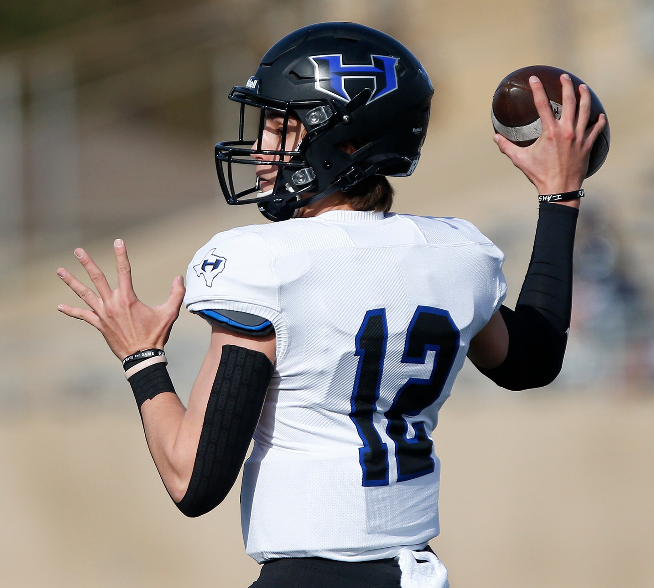 Hebron High School quarterback Weston Conaway (12) throws a pass during the first half as...