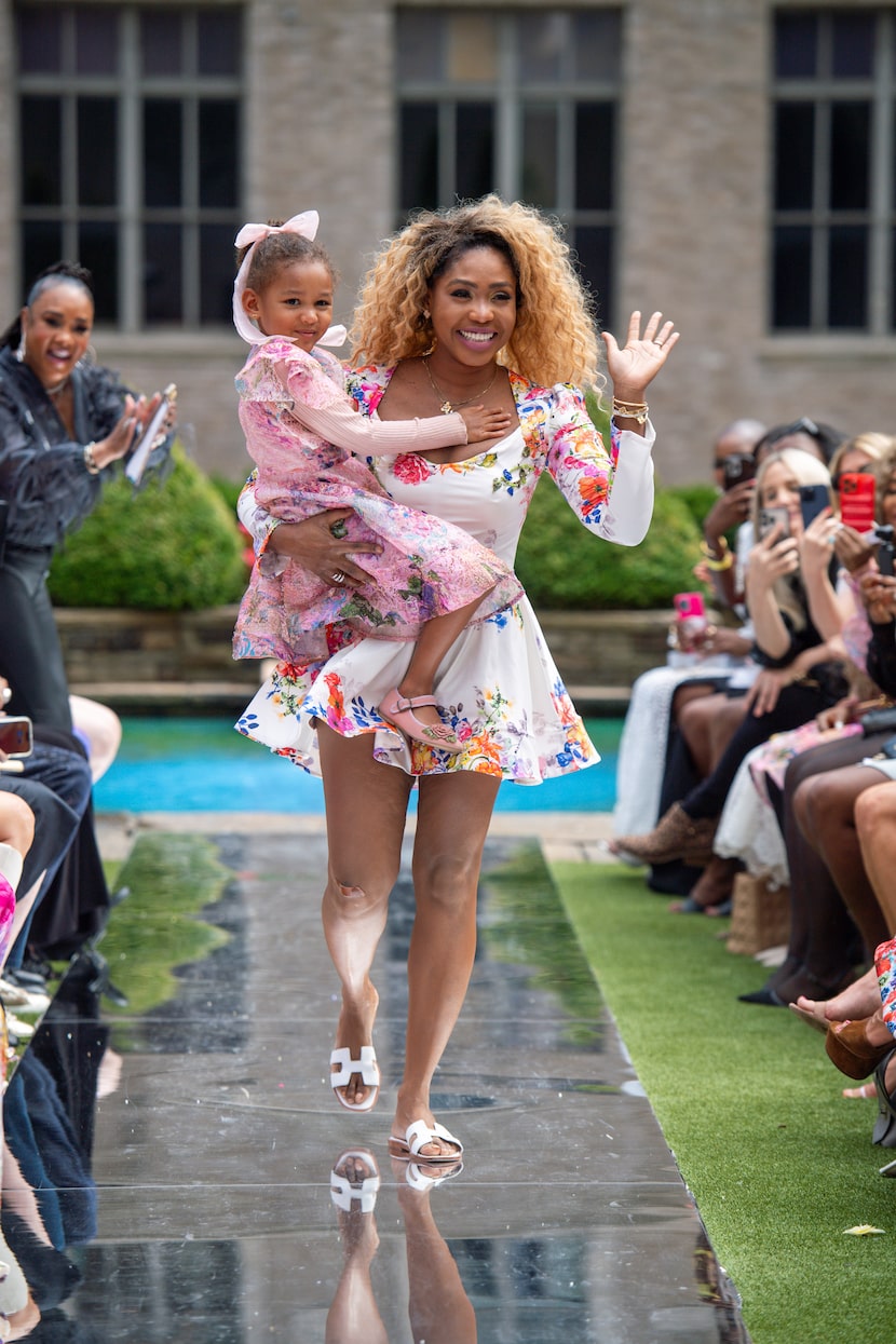 Es  Az nabor Grembowski holds her daughter, Elah, as part of the grand finale of her Fashion...