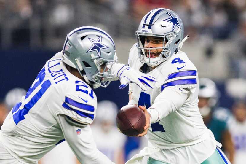 FILE - Cowboys quarterback Dak Prescott (4) hands the ball off to running back Ezekiel...