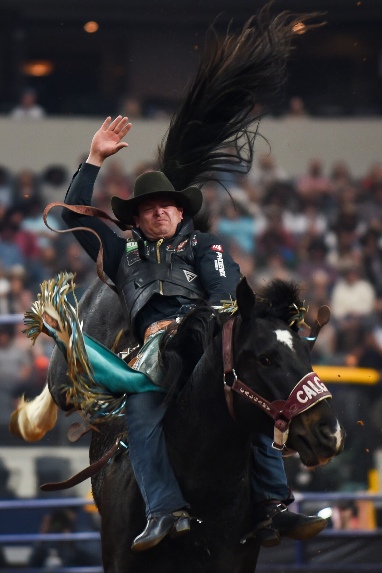 Tanner Aus attempt to stay on his horse as a part of the Bareback Bronc event during the...