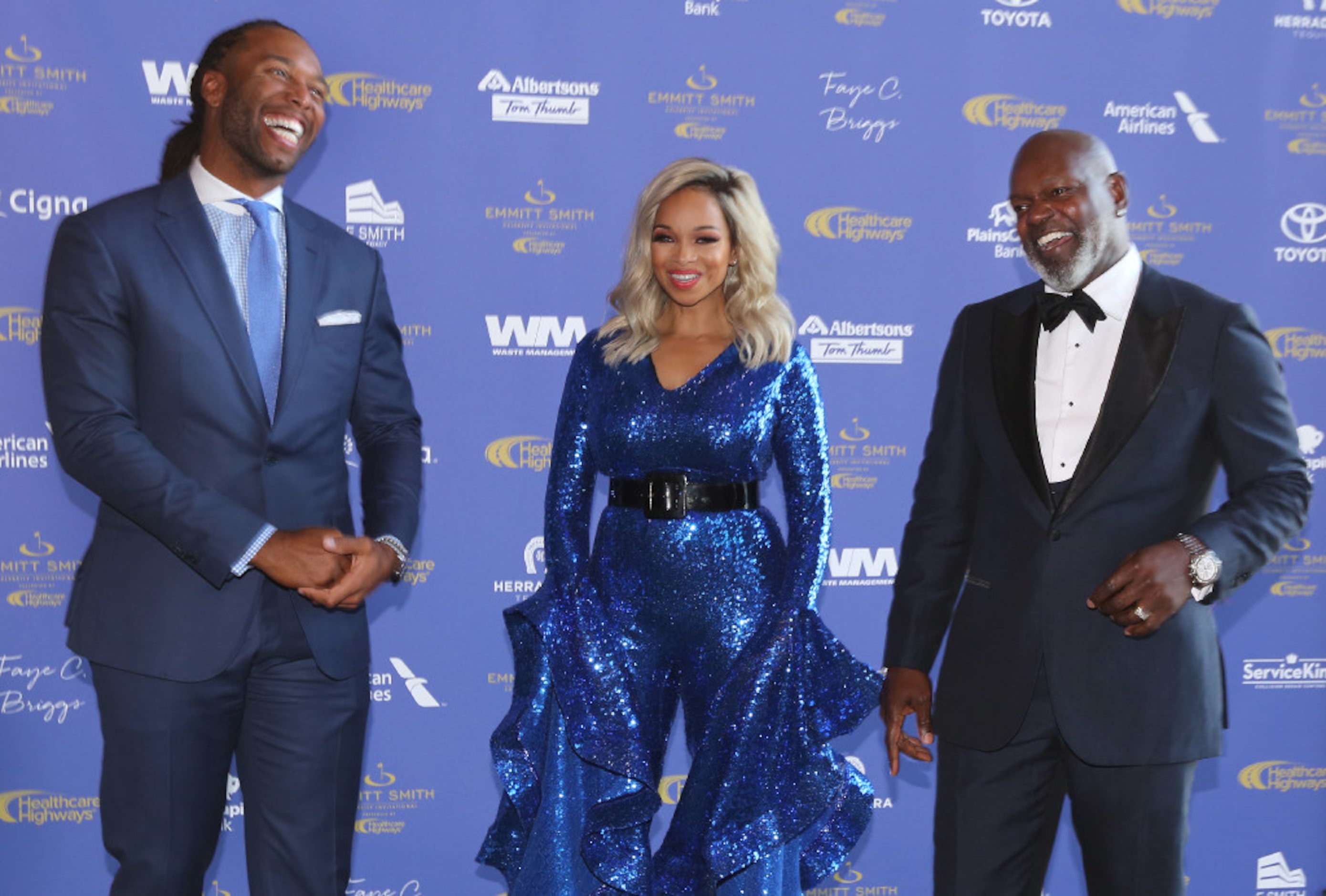 Award recipient Larry Fitzgerald shares a laugh with Emmitt and Pat Smith during the red...