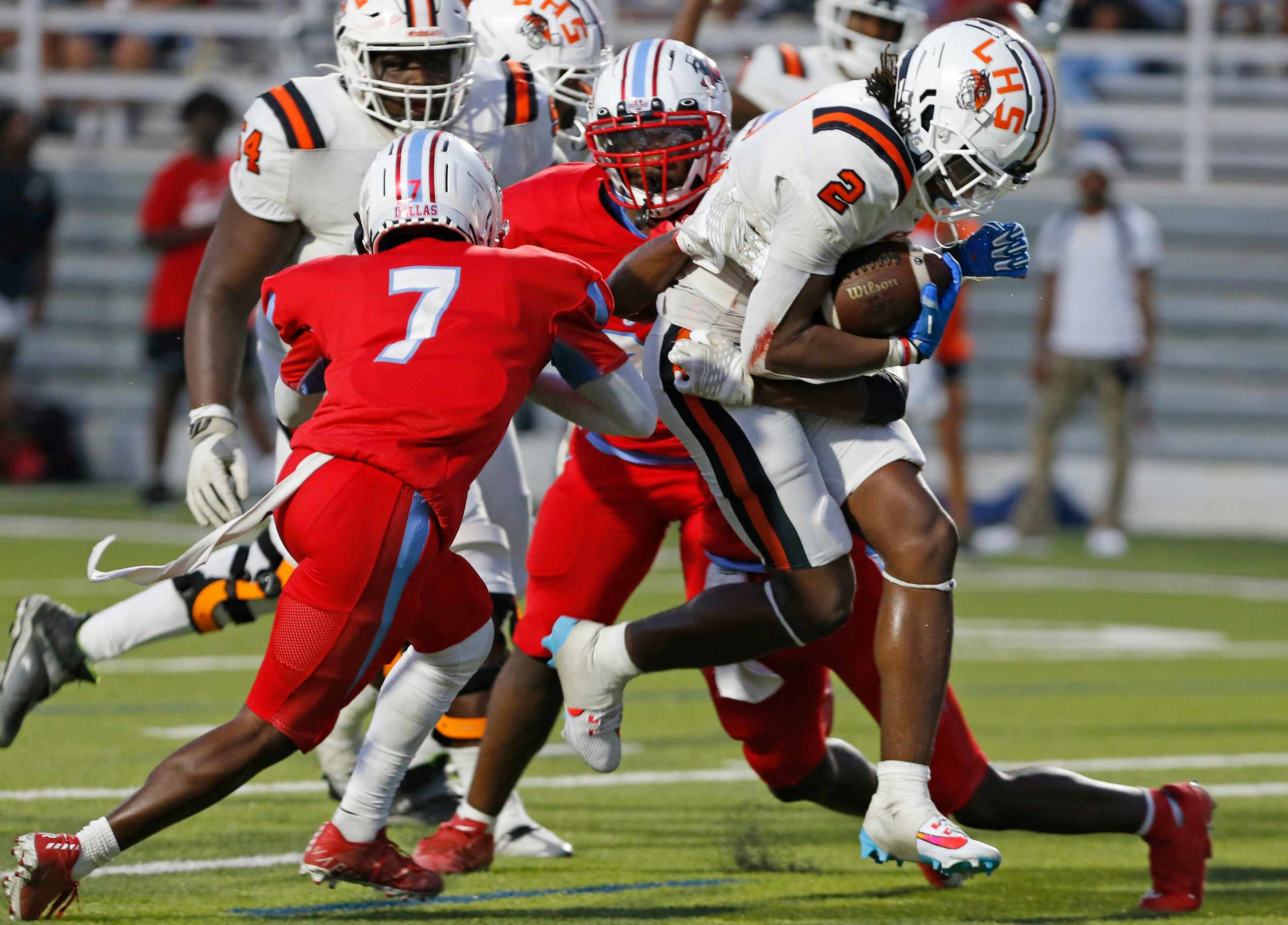 Lancaster High’s Kewan Lacy (2) plows through Skyline High defenders for a in ,route to a...