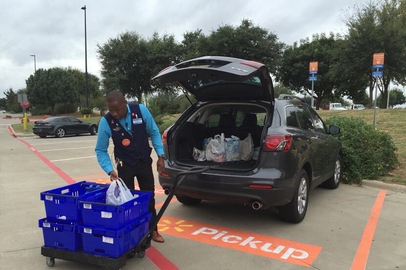  Wal-Mart Supercenter assistant manager Arnold Dube loaded groceries Thursday, Oct. 21, the...