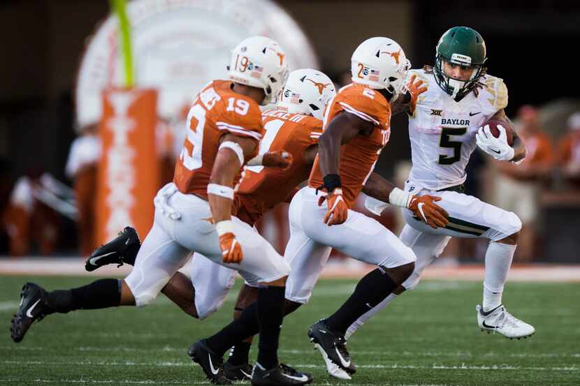 Baylor Bears wide receiver Jalen Hurd (5) is tackled by Texas Longhorns defenders during the...