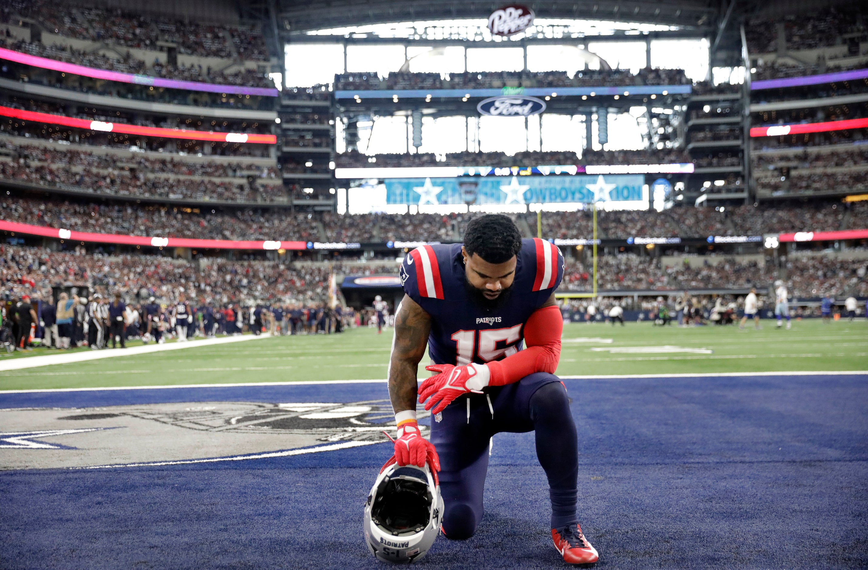 New England Patriots running back Ezekiel Elliott (15) takes a knee in the end zone before...