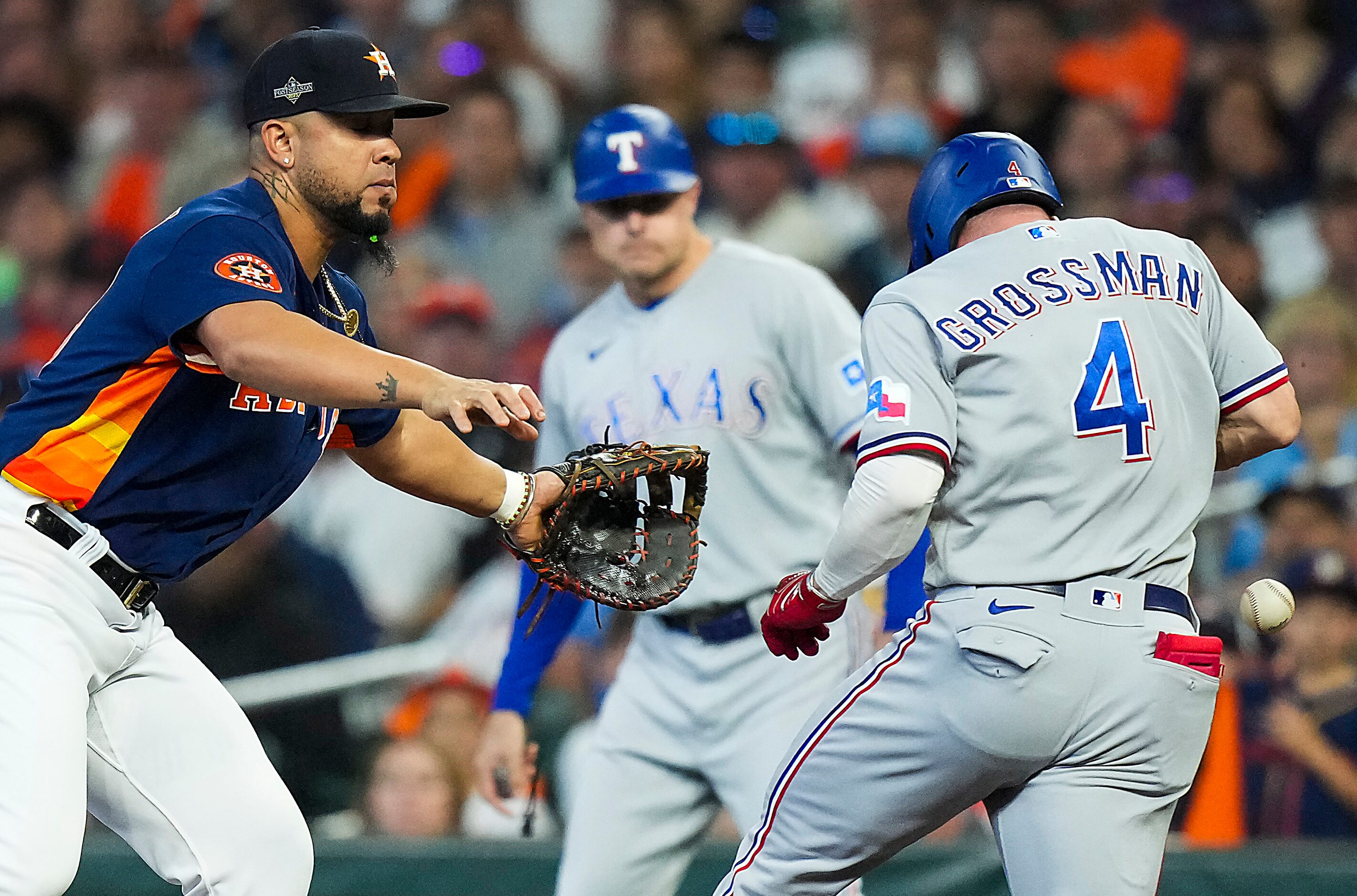 Texas Rangers left fielder Robbie Grossman (4) reaches first base on an error by Houston...