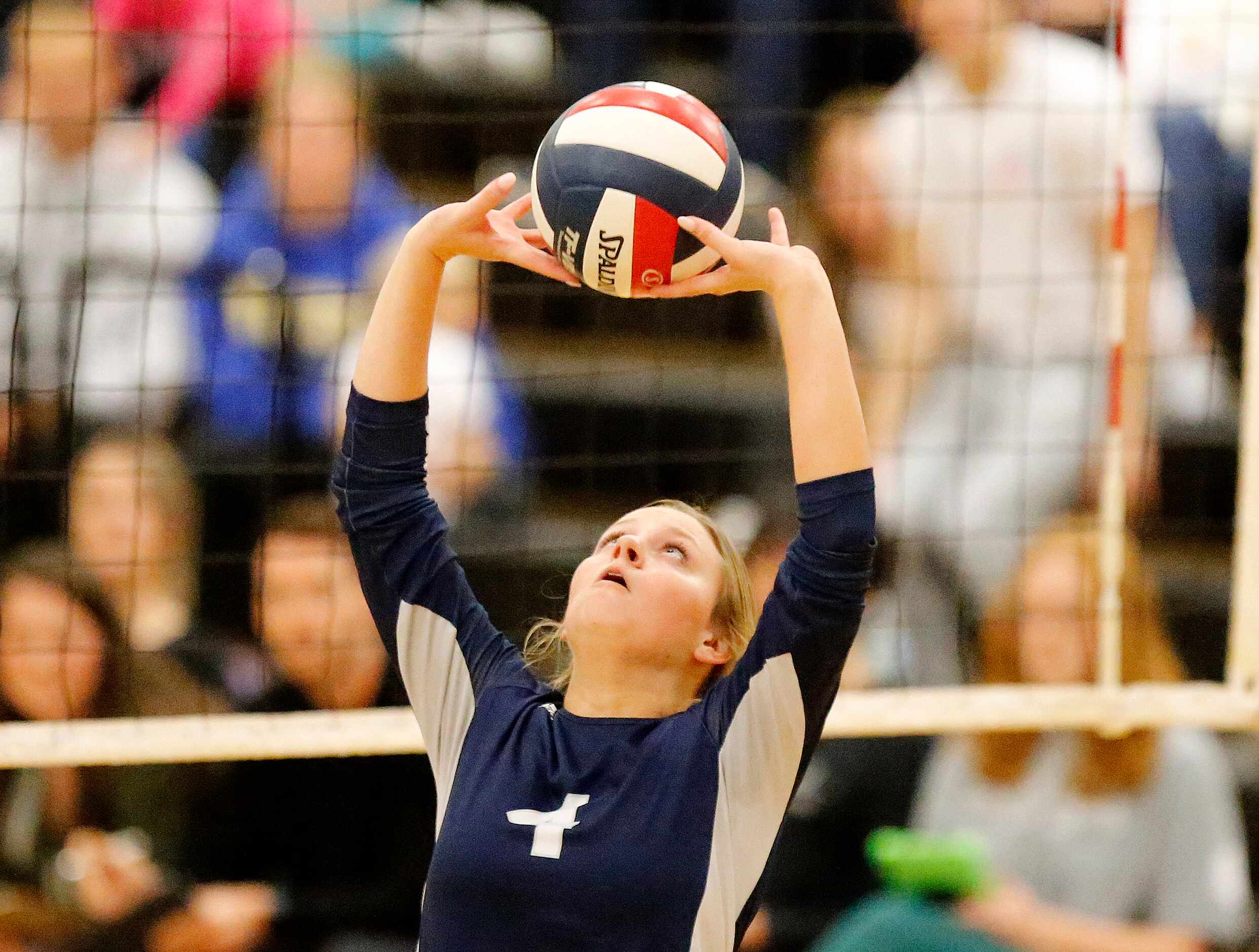 Flower Mound High School setter Avery Miller (4) makes a set during game one of the first...