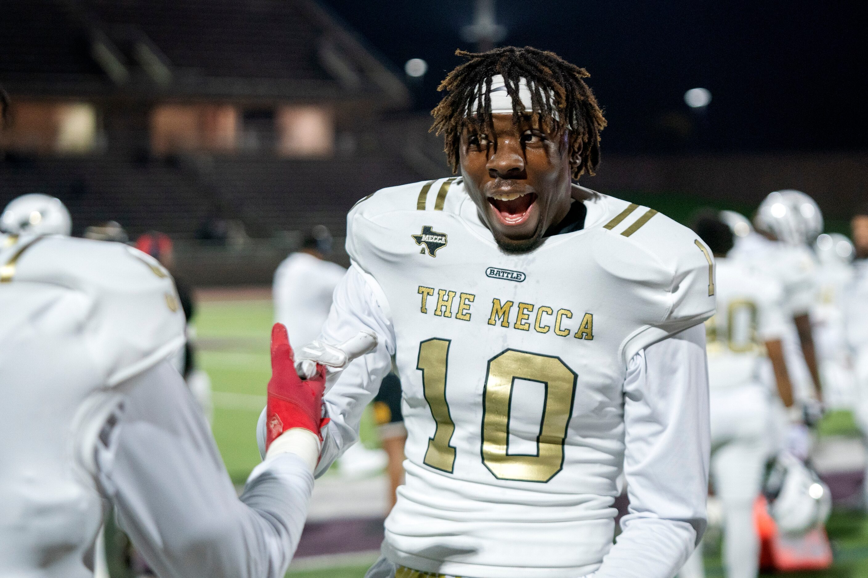 South Oak Cliff senior defensive lineman Billy Walton (10) jokes with teammates during the...