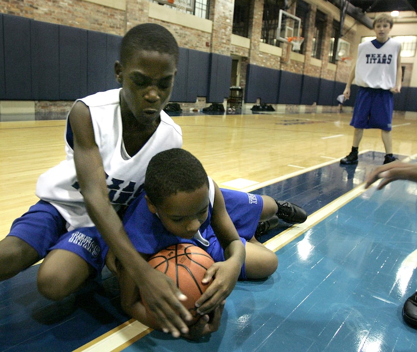 Texas Titans third grade AAU team members Michael McReynolds, right, and Sotonye Jamabo...