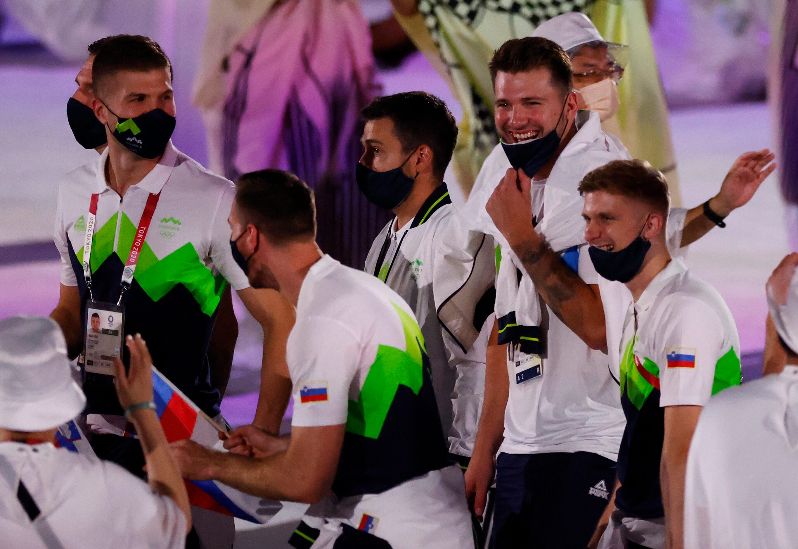 Slovenia’s Luka Doncic shares a laugh with is fellow Slovenian Olympic athletes as they make...