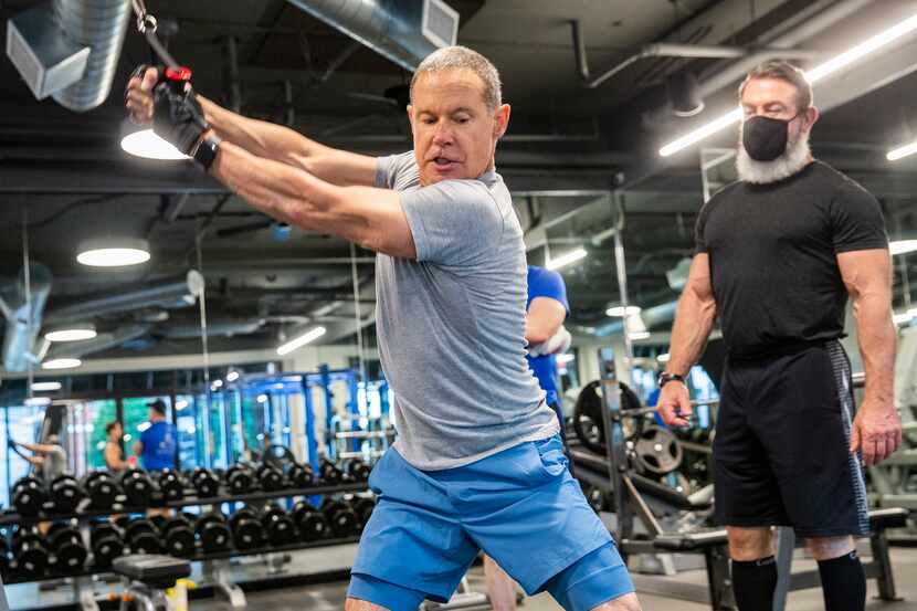 Bill Kritzer works out with Trophy Fitness trainer John Gordon at the Uptown gym on May 18,...