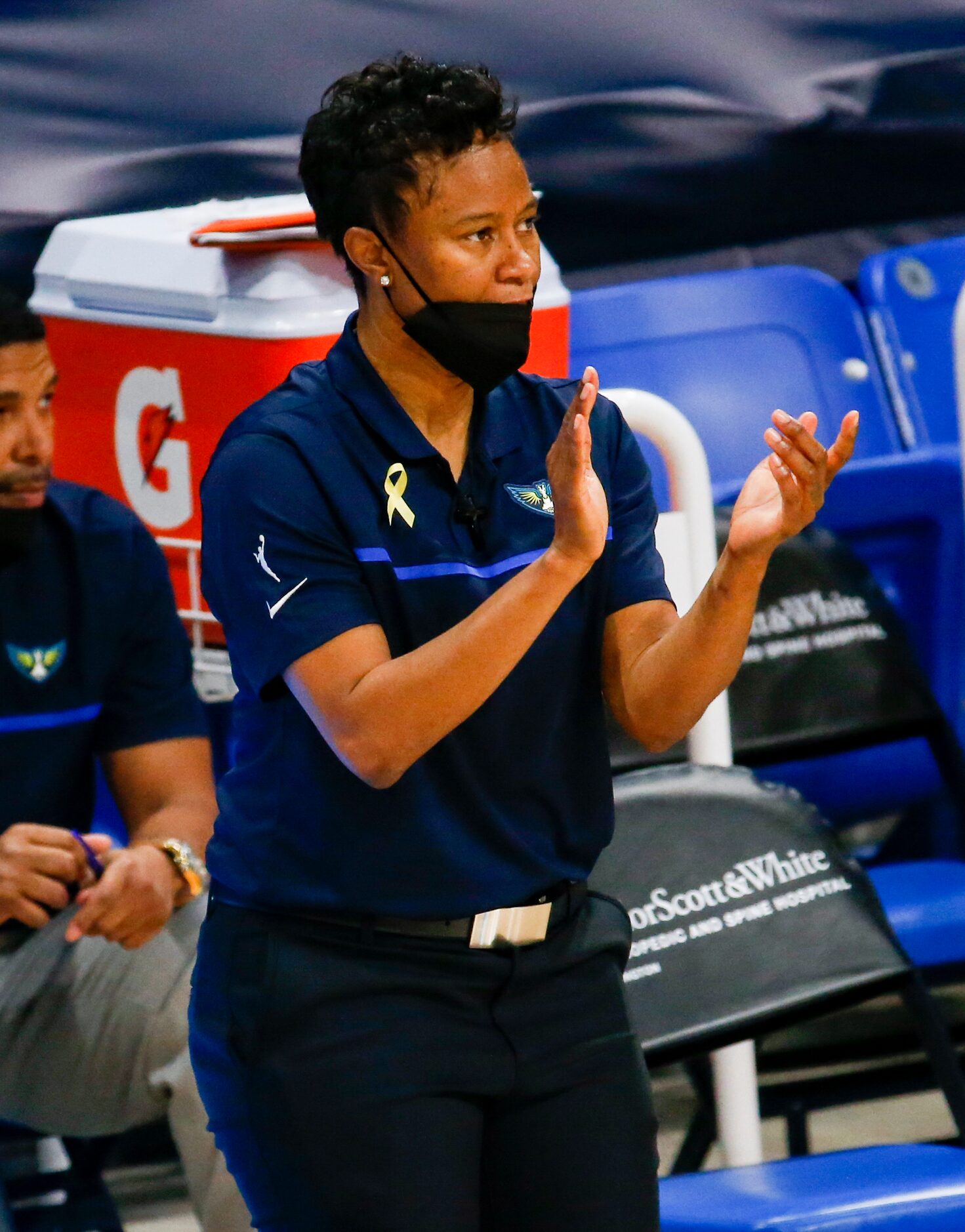 Dallas Wings coach Vickie Johnson claps as her team plays against the Los Angeles Sparks at...