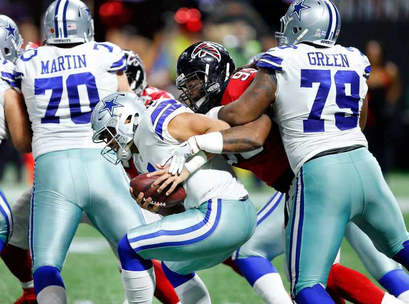 FILE - Cowboys offensive tackle Chaz Green (79) tries to keep Falcons defensive end Adrian...