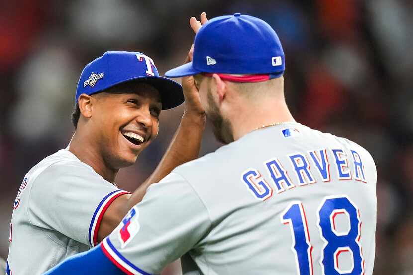 Texas Rangers relief pitcher Jose Leclerc celebrates with Mitch Garver after the final out...