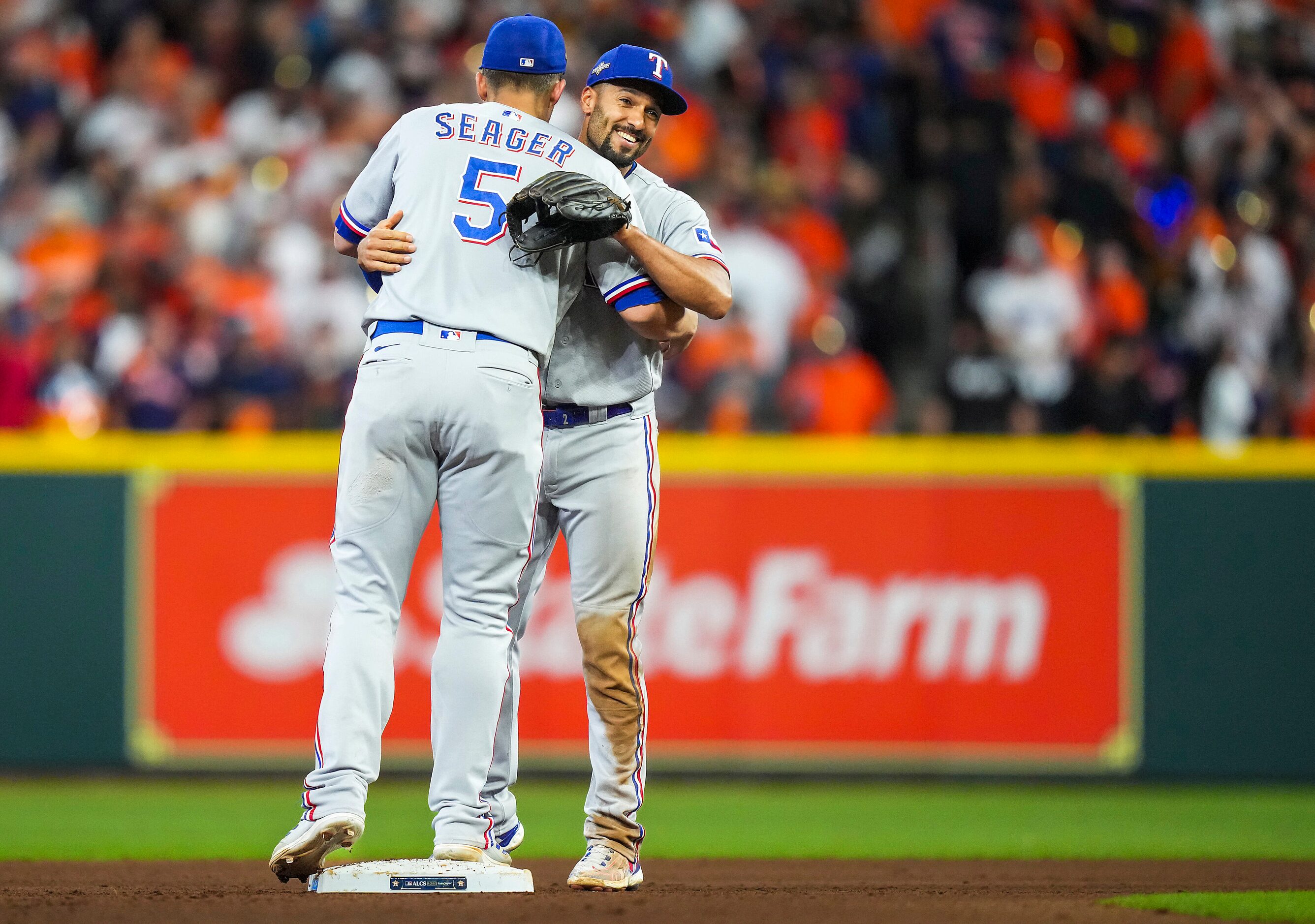 Texas Rangers second baseman Marcus Semien celebrates with shortstop Corey Seager after the...