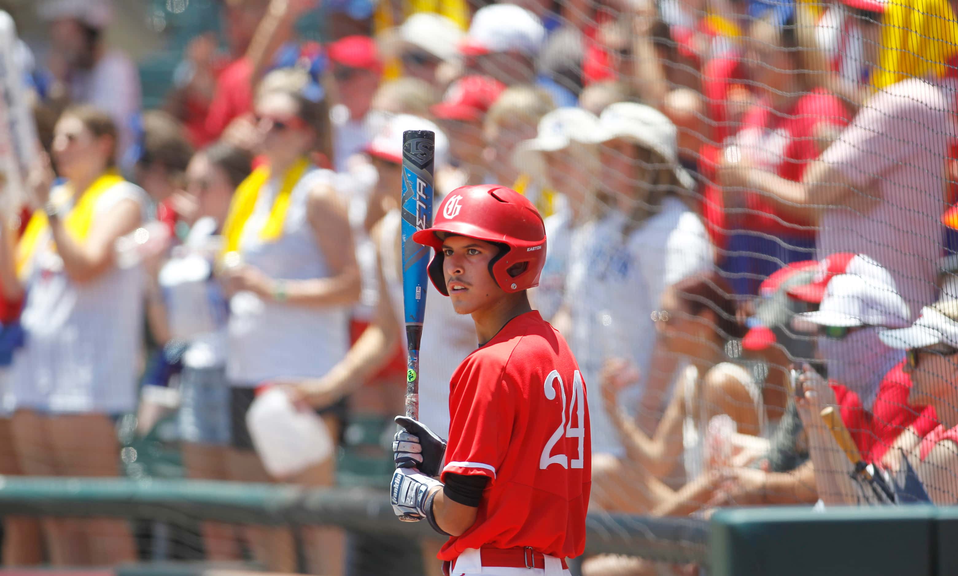 Grapevine catcher Gianni Corral (24) awaits his turn to bat in the bottom of the 1st inning...