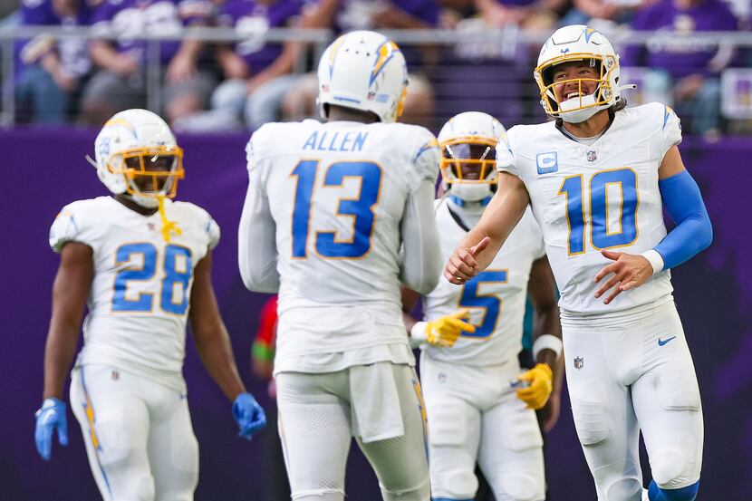 Los Angeles Chargers quarterback Justin Herbert (10) celebrates with teammates after scoring...