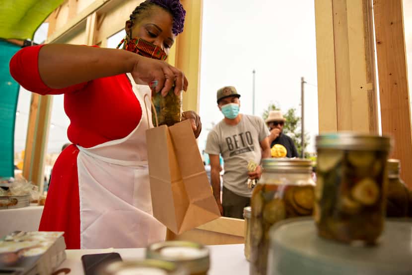 Shanay Wise of Catering Done Wisely packed just-purchased pickles at the launching of the...