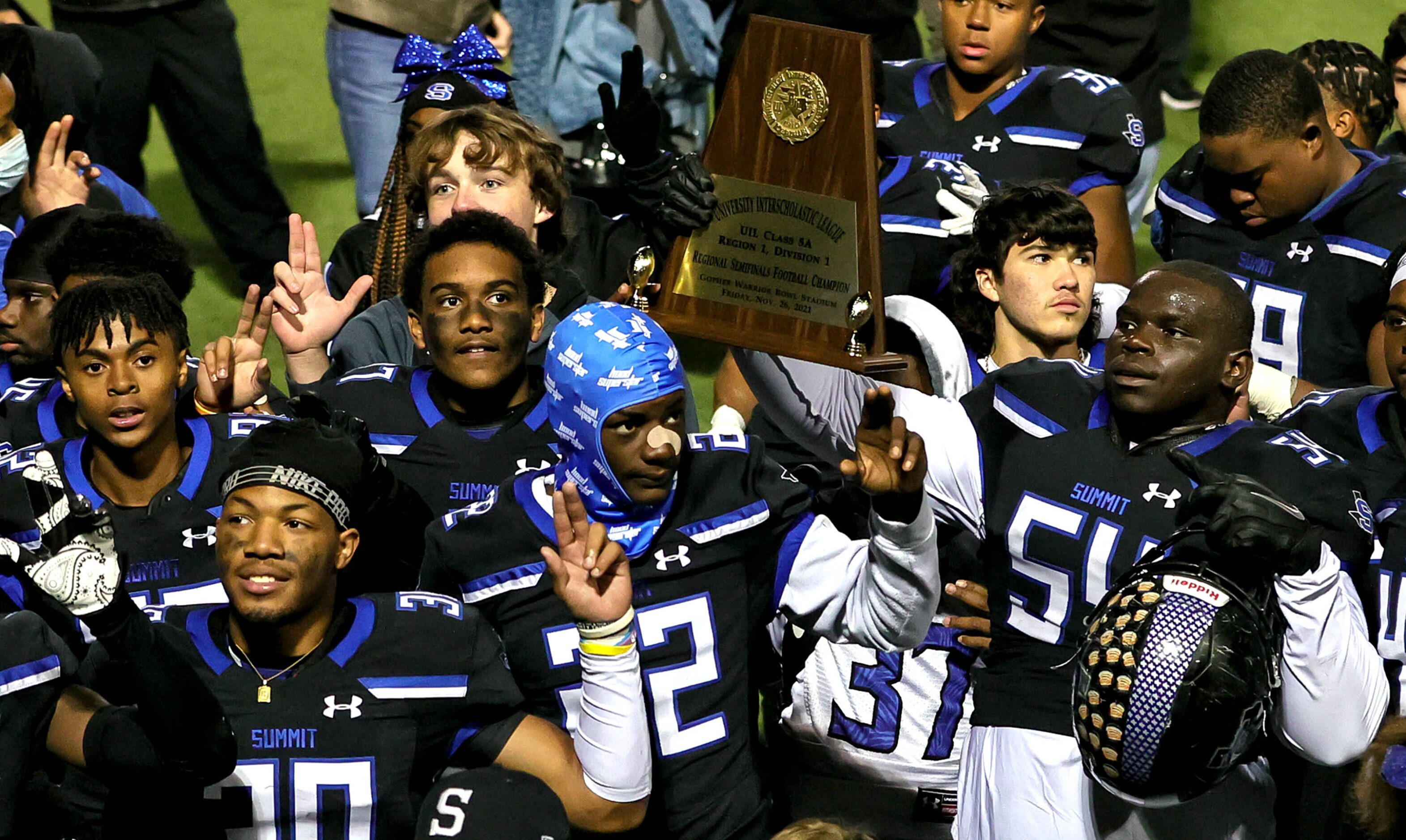 Mansfield Summit holds up their trophy after beating Midlothian, 28-20 in the 5A Division I...