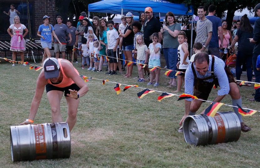 Wendi Ryan of Oak Point races a beer keg against Ryan Renke of Plano during the city of...