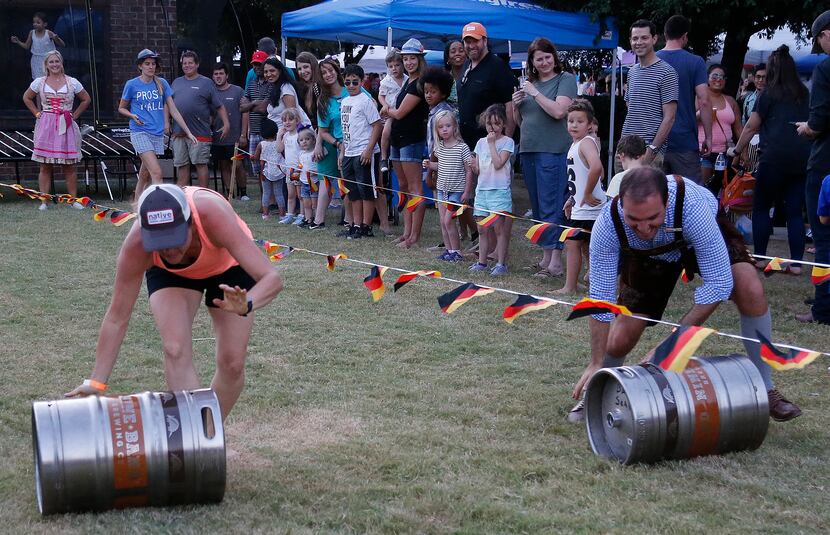 Wendi Ryan of Oak Point races a beer keg against Ryan Renke of Plano during the city of...