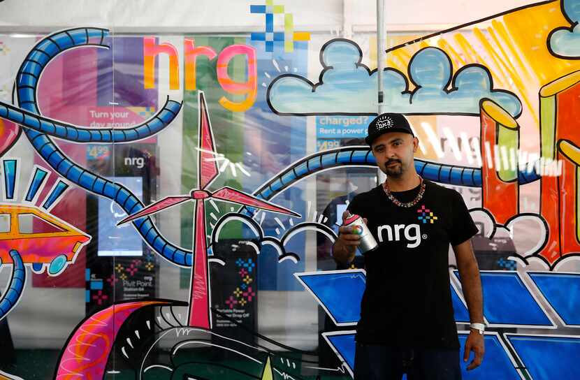 Houston artist, GONZO247, poses for a photo in front of his artwork at Free Press Summer...