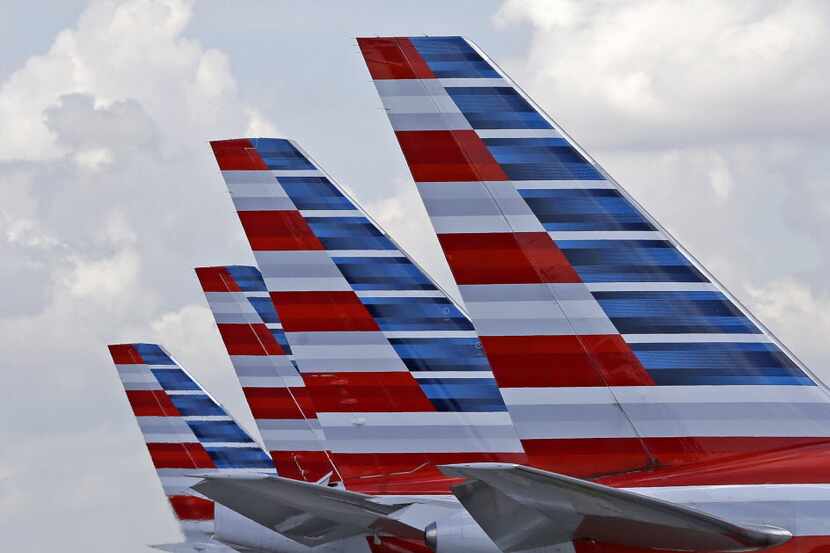 FILE - This photo July 17, 2015, photo shows the tails of four American Airlines passenger...