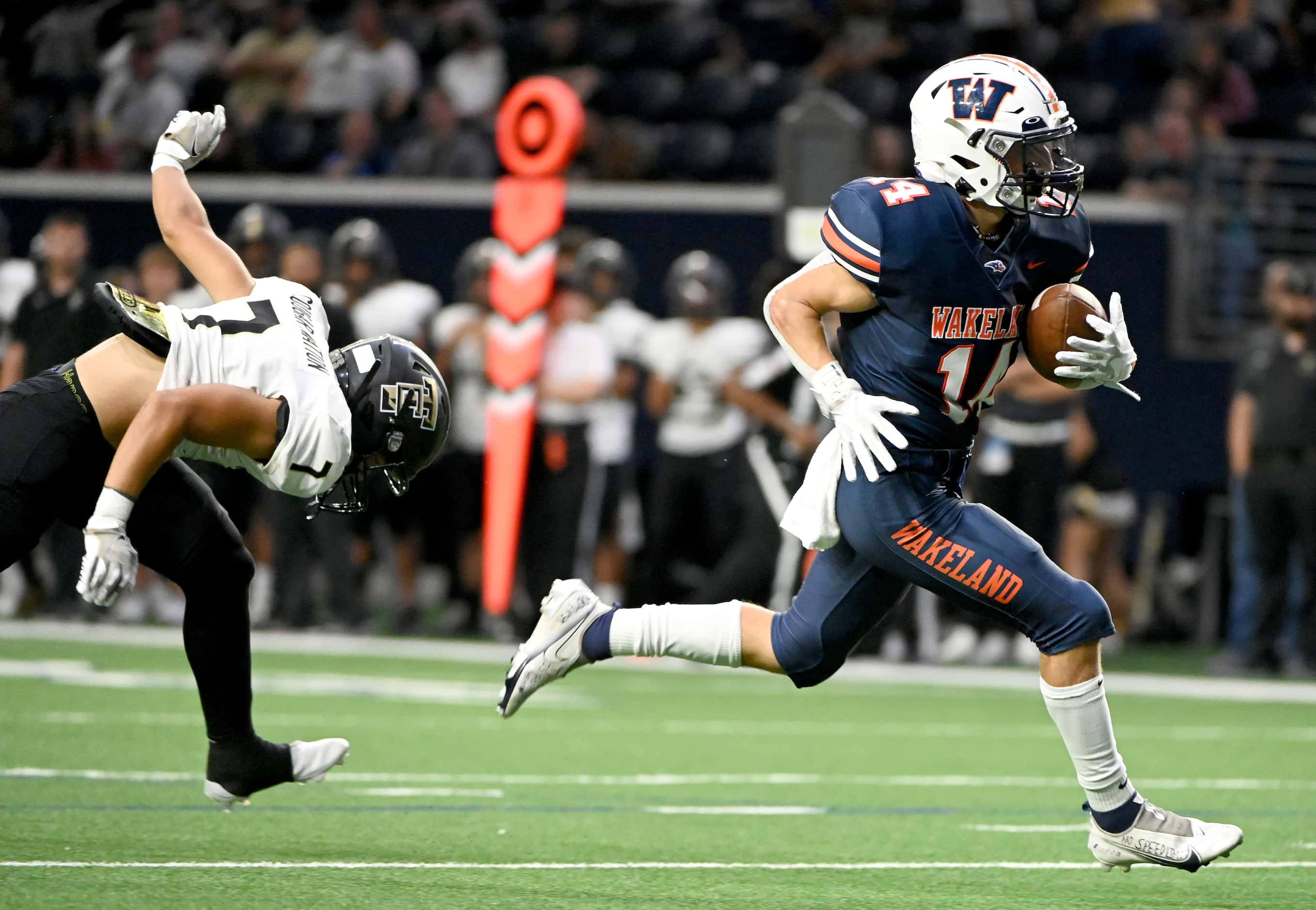 Frisco Wakeland's Ashdyn Kahouch (14) runs past The Colony's Jaylin Prince (7) on his way to...