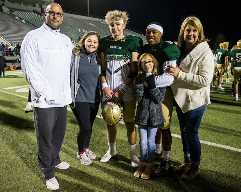 From left, John Earle, Ali Earle, Birdville quarterback Stone Earle (3), running back...