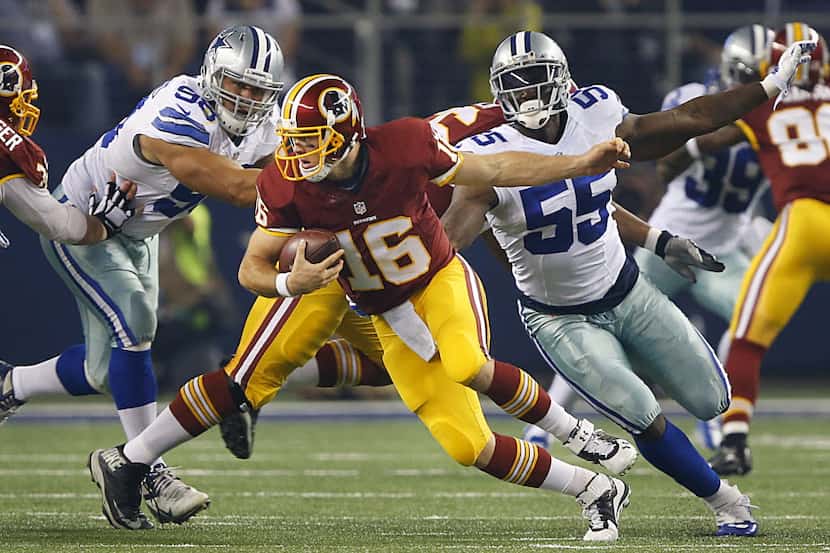 Washington Redskins quarterback Colt McCoy (16) escapes the Dallas Cowboys defense in the...