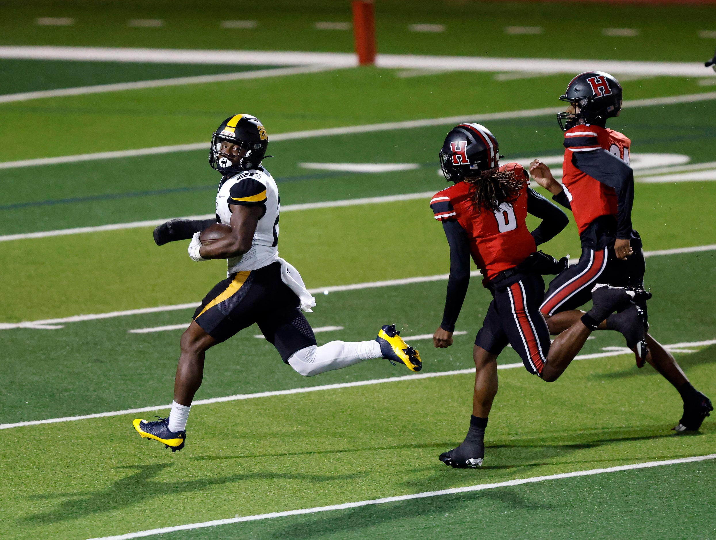 Forney running back Javian Osborne (26) looks back over his shoulder at Rockwall-Heath’s...