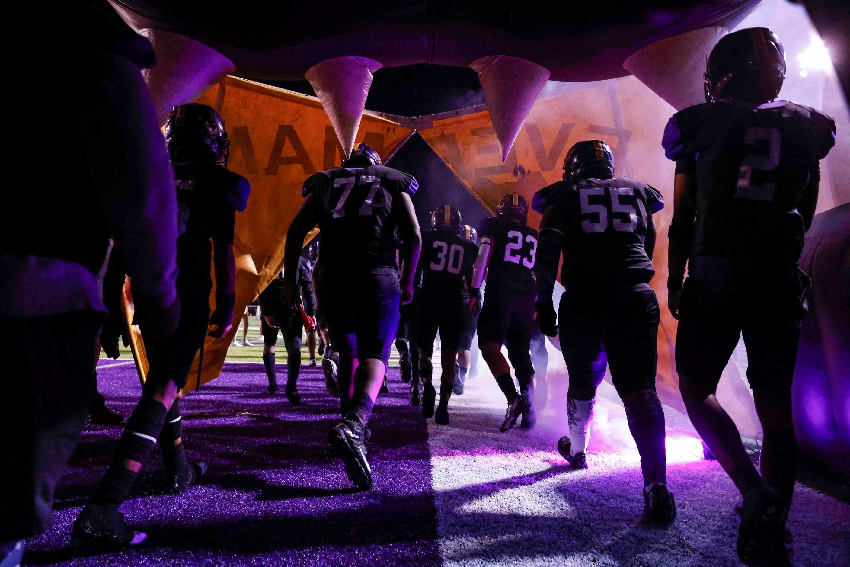 Everman High players enter the field ahead of their game against Midlothian Heritage at J E...