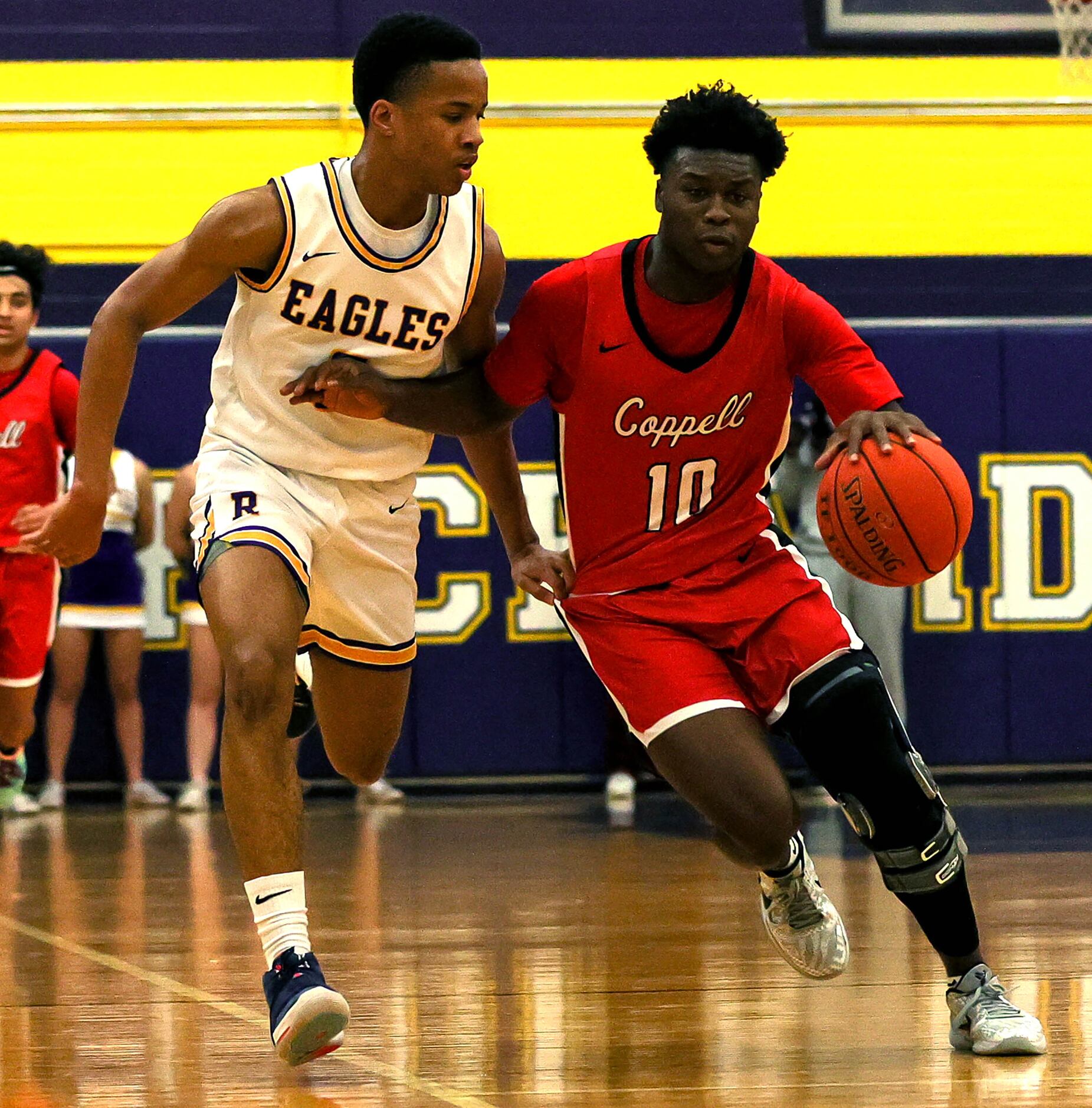Coppell guard Nazir Brown (10) tries to dribble past Richardson guard Pharaoh Amadl (L)...