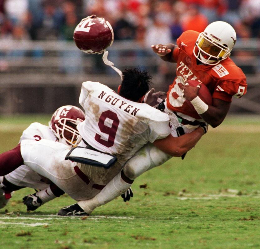 ORG XMIT:  (l-r)Texas A&M Shun Horn, #21 and Dat Nguyen, # 9, and tackle University of Texas...