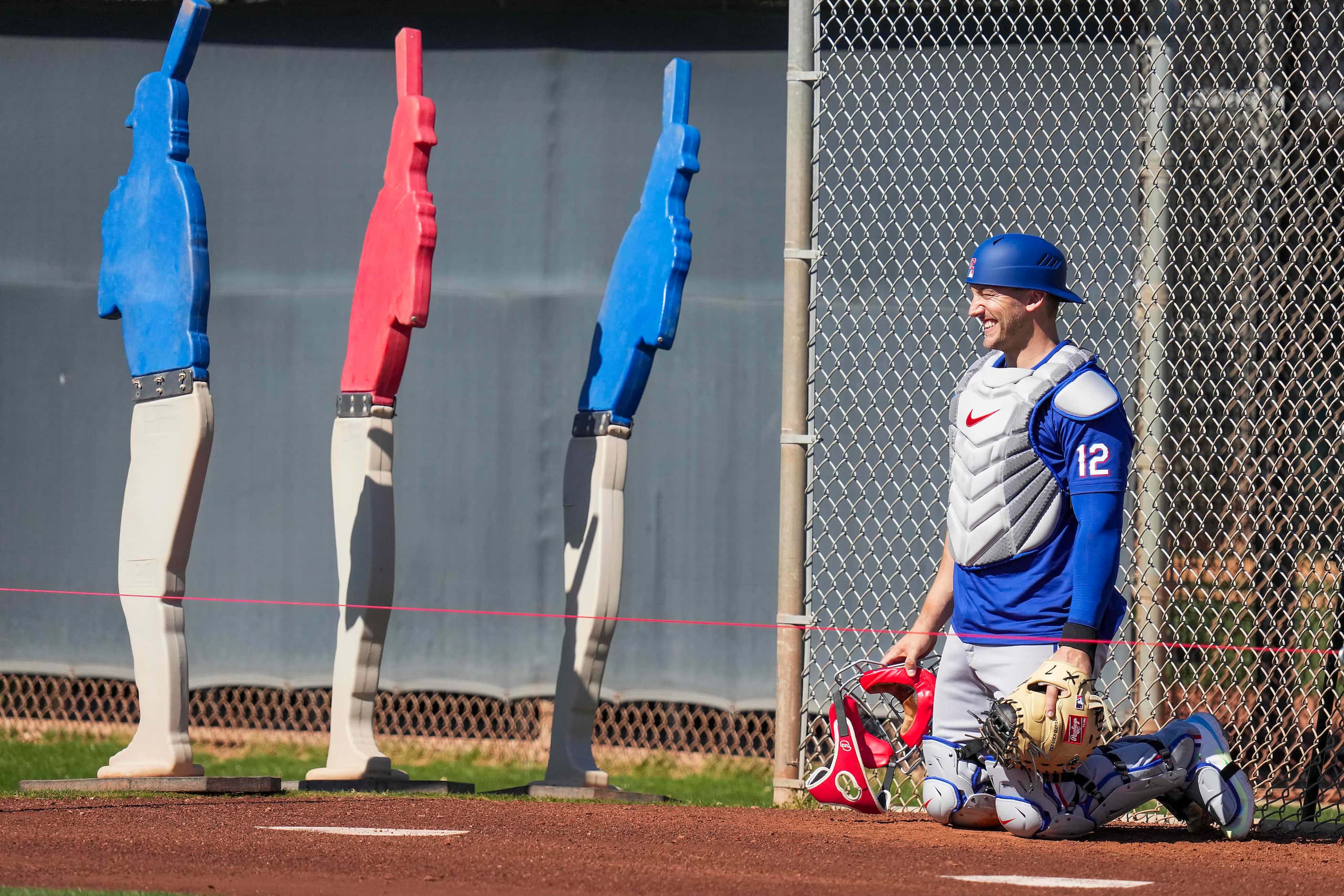 Texas Rangers catcher Andrew Knizner works in the bullpen during the first Spring Training...