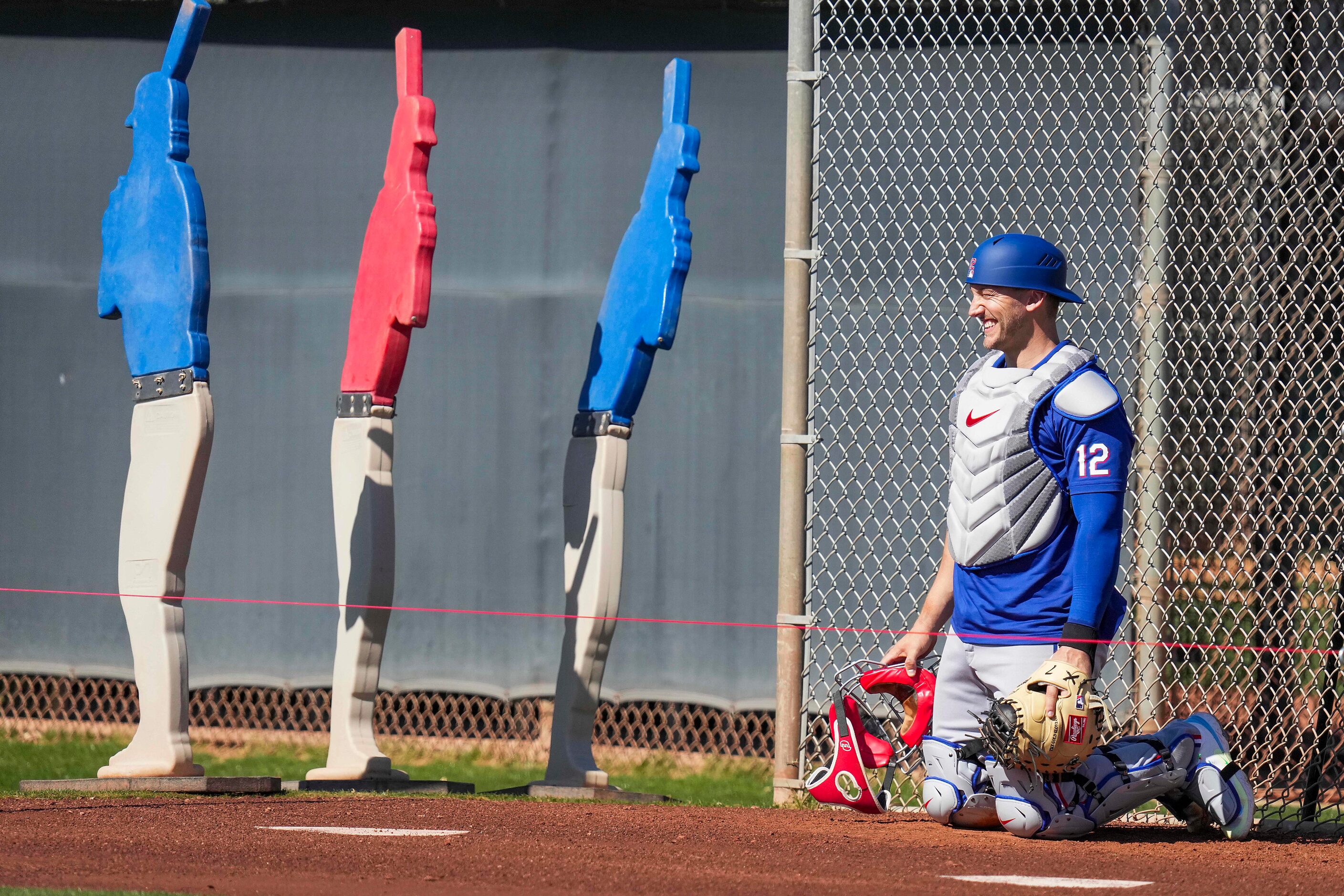 Texas Rangers catcher Andrew Knizner works in the bullpen during the first Spring Training...